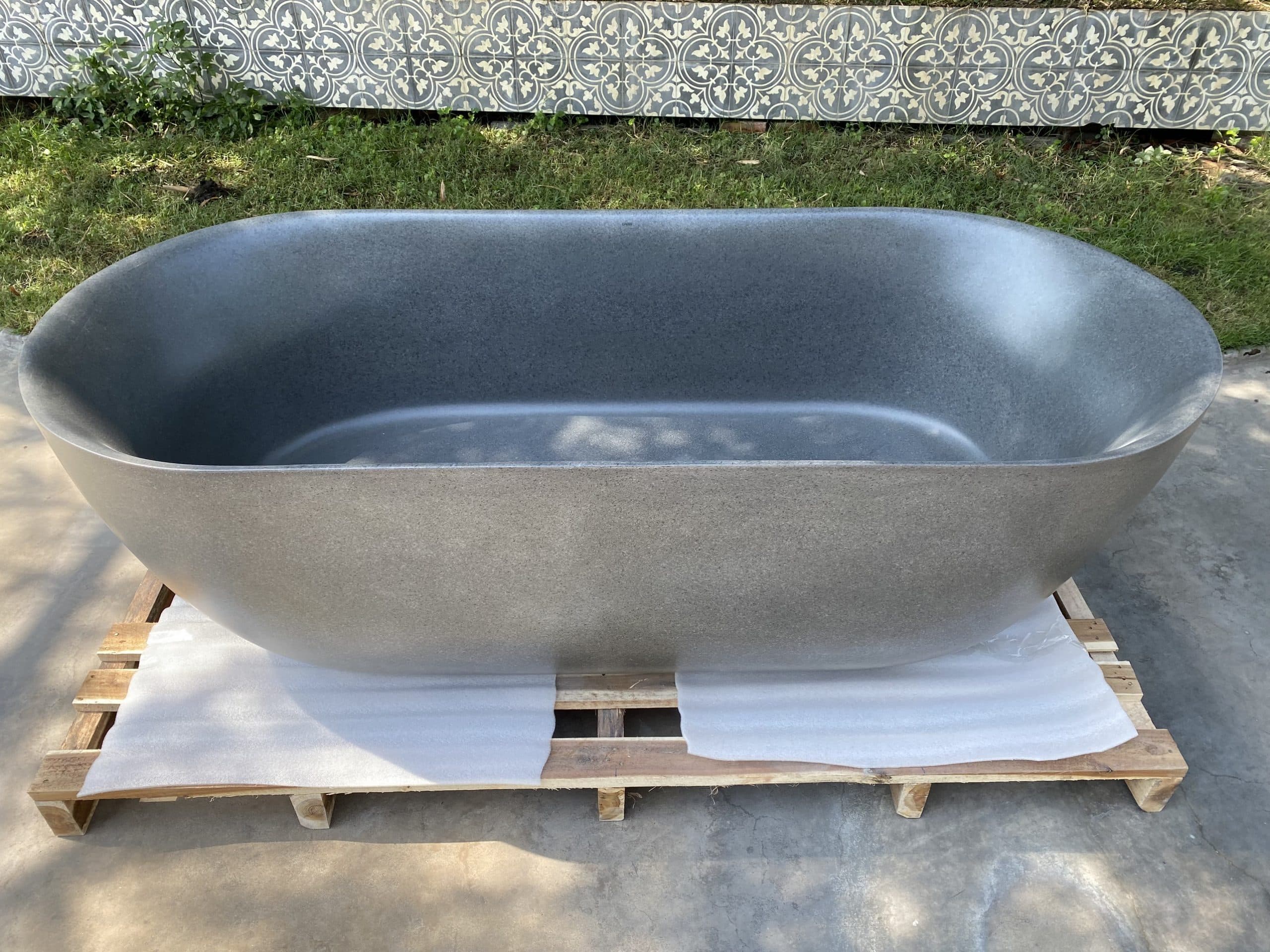 Side view of DR23T solid surface freestanding bathtub in natural light